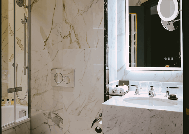 Shower over bath and sink inside bathroom at The Mayfair Townhouse