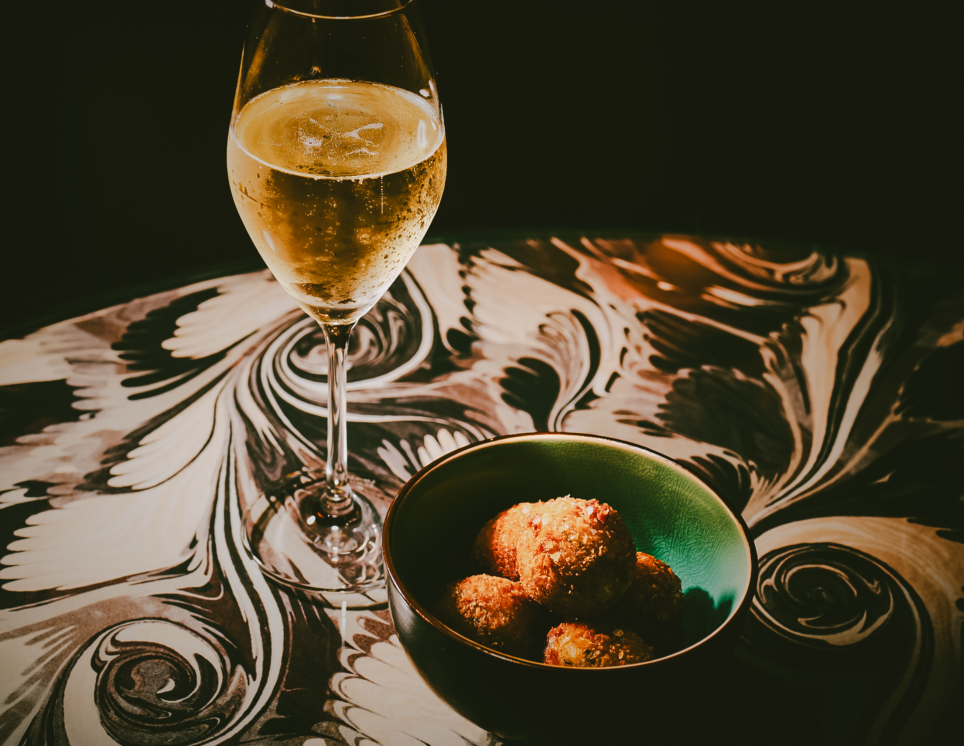 Glass of prosecco and snacks at The Dandy Bar at The Mayfair Townhouse