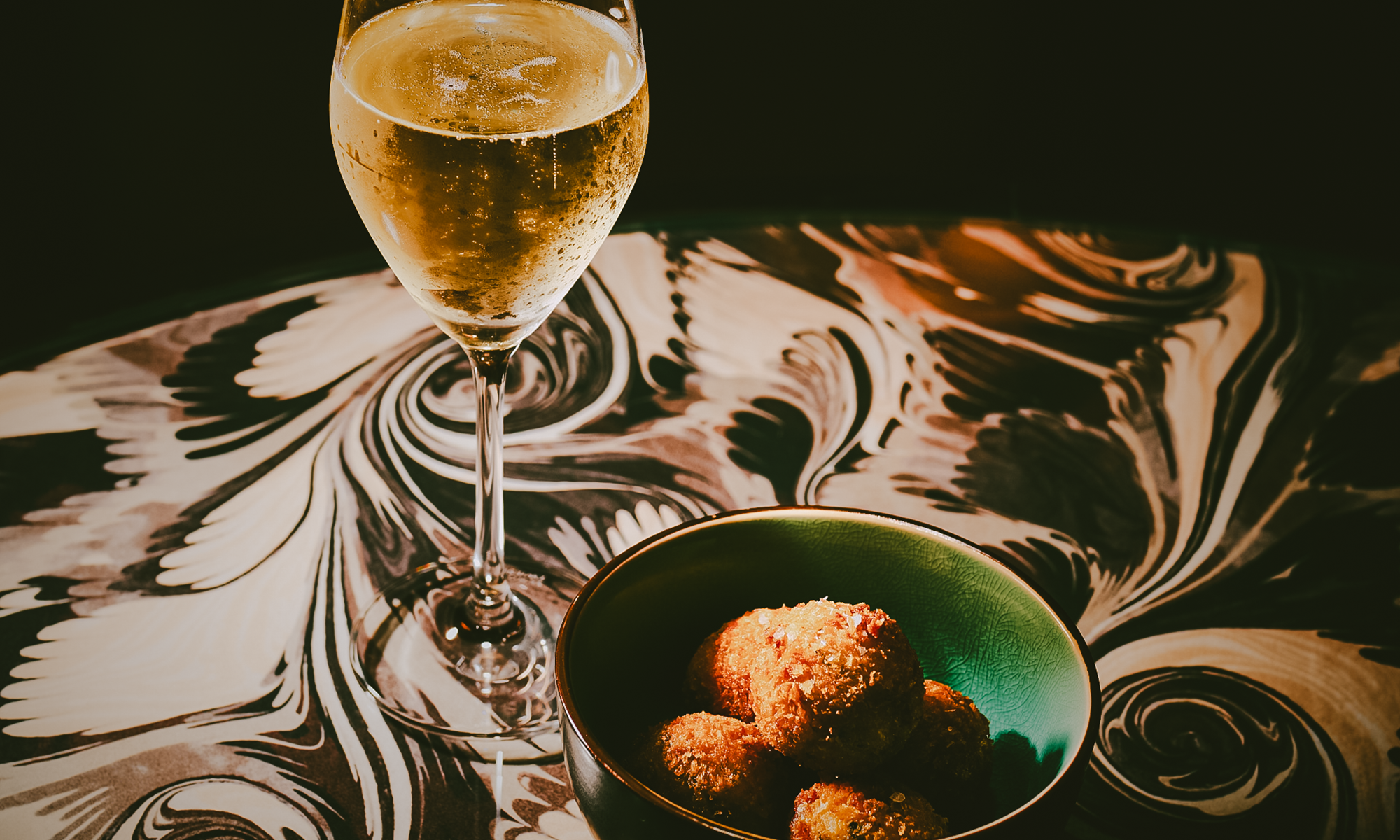 Glass of prosecco and snacks at The Dandy Bar at The Mayfair Townhouse