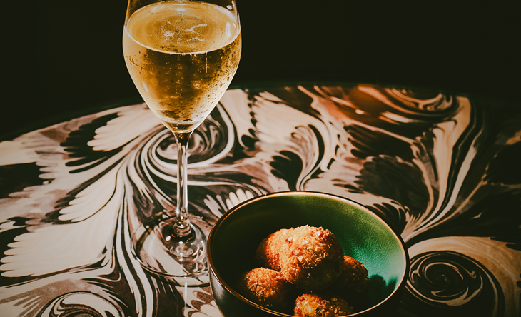 Glass of prosecco and snacks at The Dandy Bar at The Mayfair Townhouse