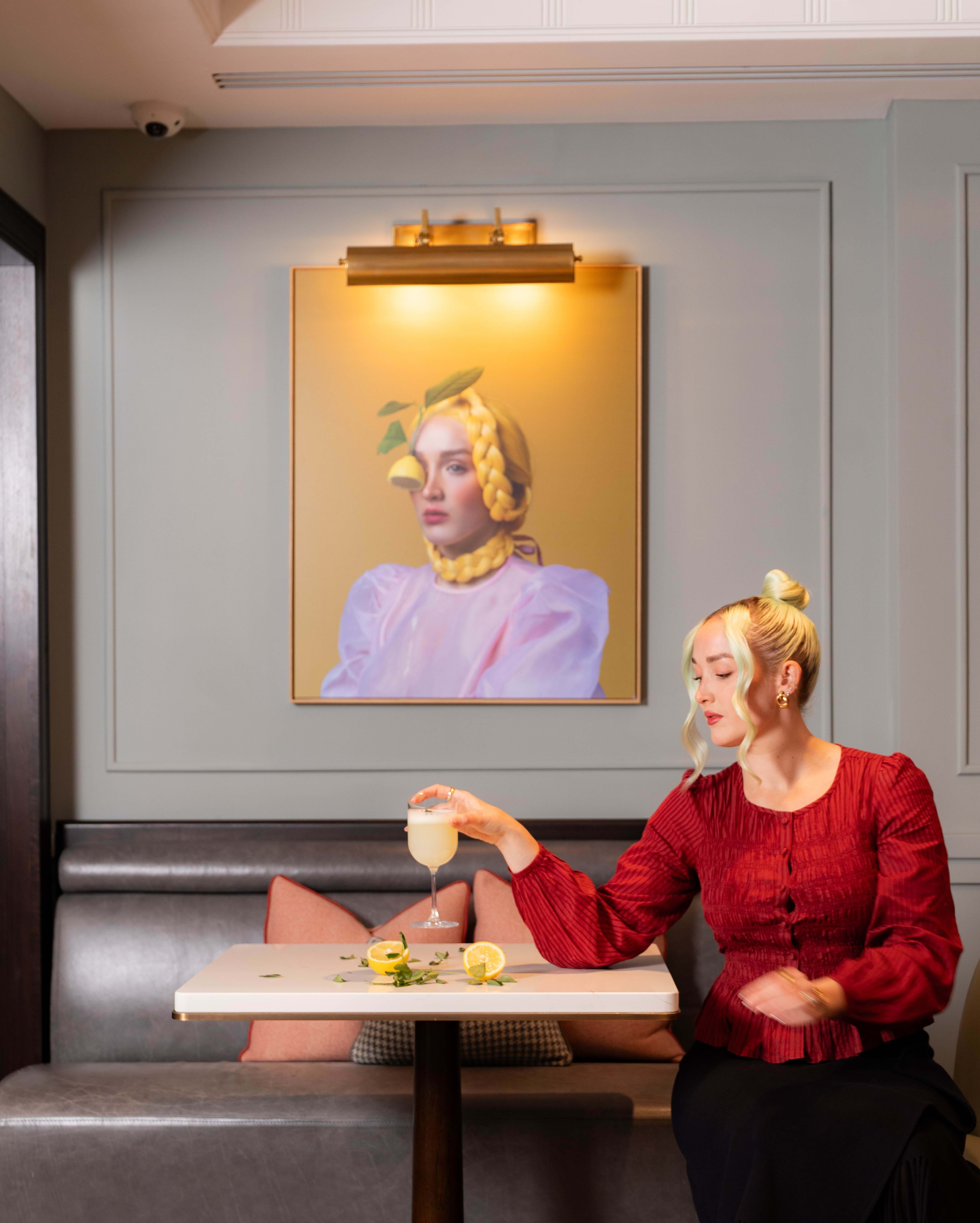 Artist with her paintings