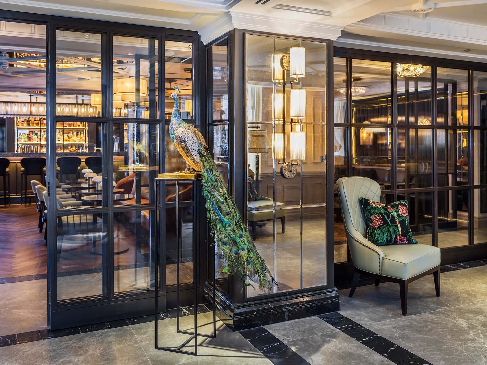 Side view of peacock sculpture in the lobby at The Mayfair Townhouse in London
