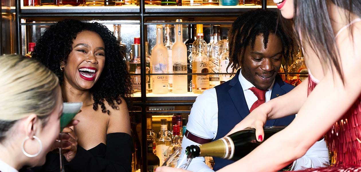 pouring champagne in the dandy bar mayfair